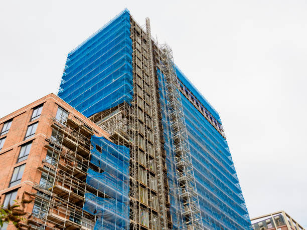 istock Tall building under construction with blue safety netting and scaffolding. 2175307125