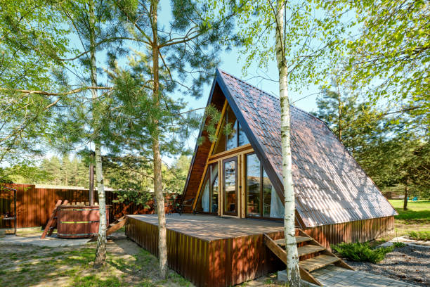 istock Charming A-frame cabin nestled among trees in a serene outdoor setting during bright daylight 2175307825