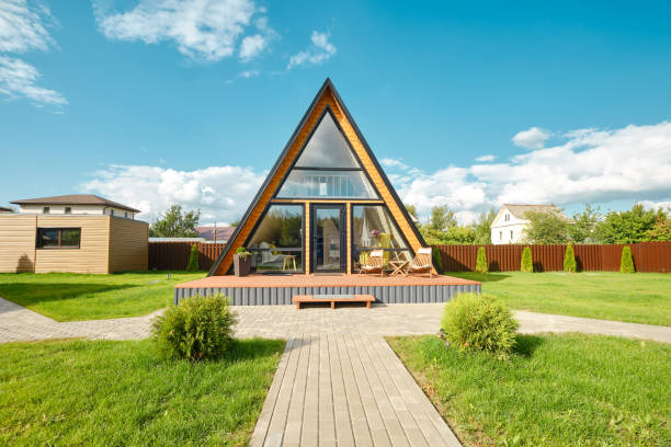 istock Modern A-frame house surrounded by greenery in a tranquil suburban setting on a sunny day 2175307861