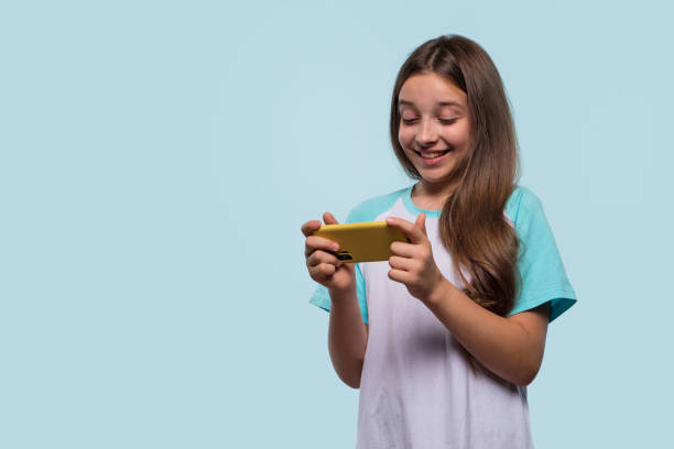 istock Girl using phone, enjoying engaging moment on screen. 2175317191