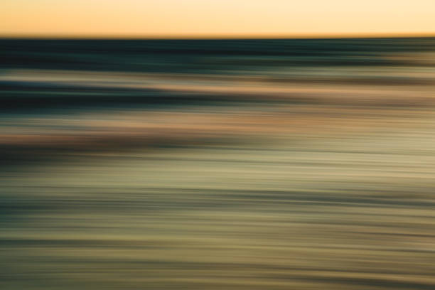istock Blurred sunset reflection over the ocean with soft golden tones. 2175319681