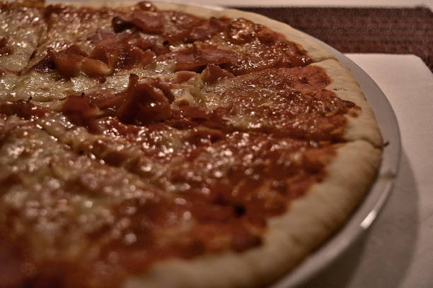 Gooey, melted cheese covers a freshly baked pizza, highlighting the delicious toppings and inviting texture.