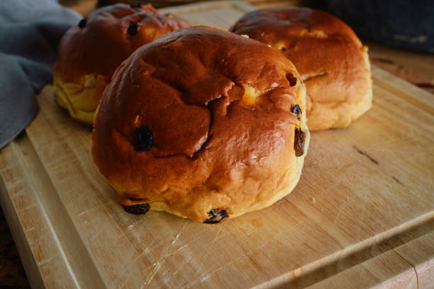 A close-up, top-down shot capturing the fresh, golden-brown homemade sesame seed buns