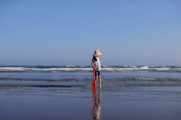 A young girl playing on the summer beach,Northern Ireland