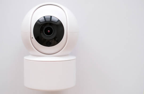 istock A white security camera with a black lens is mounted on a white surface. The camera is designed to capture images and record video footage 2175334218