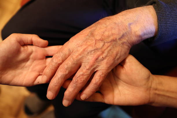 Hands of an older person and a younger one