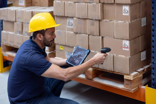 istock Man working at an e-commerce warehouse taking inventory of the merchandise 2175336453