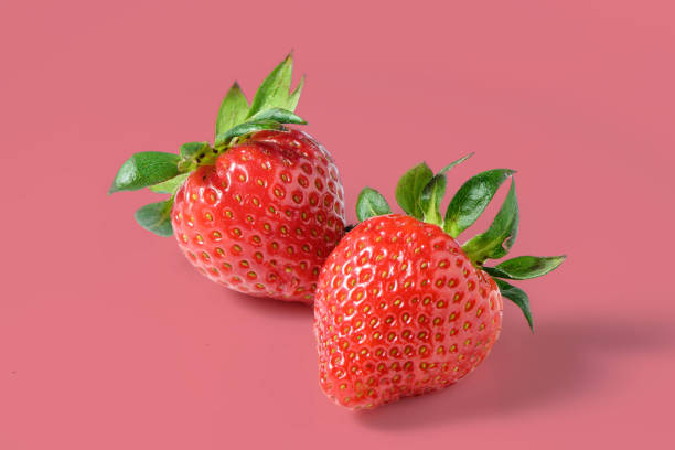istock Ripe delicious strawberry on red background 2175337394