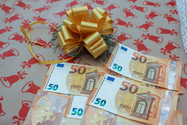 istock several fifty euro bills on a Christmas present 2175338207