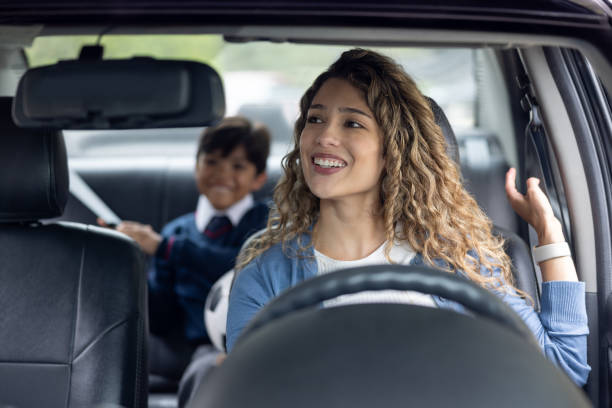 istock Happy mother picking up her son from school in her car 2175339425