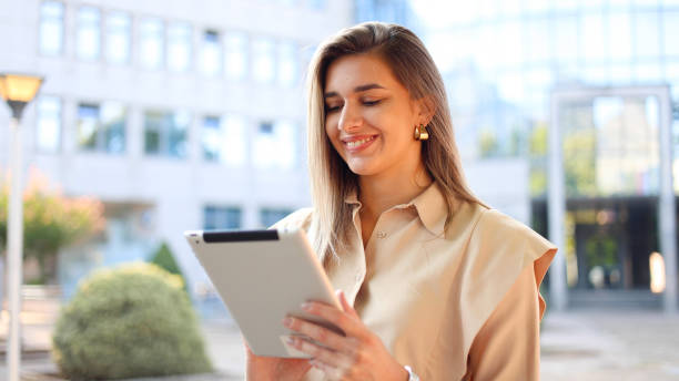 istock Female entrepreneur using a tablet in the city 2175340691