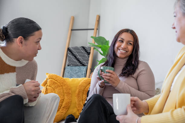 istock Sitting on the couch, three women bond over coffee and friendly conversation. 2175344594