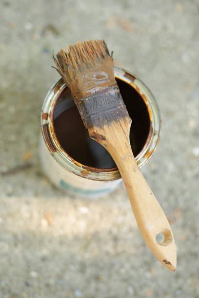 istock Paintbrush resting on an open can of paint 2175347842