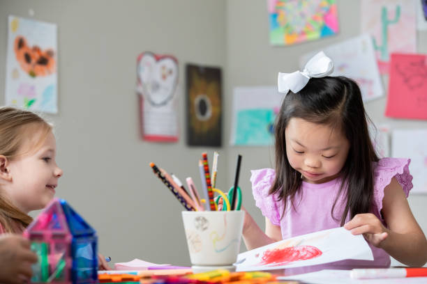 istock Elementary age student with Down Syndrome enjoys class with friends 2175352707