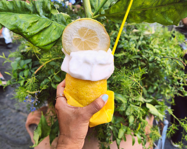 Unrecognizable female hand holding a lemon sorbet ice cream