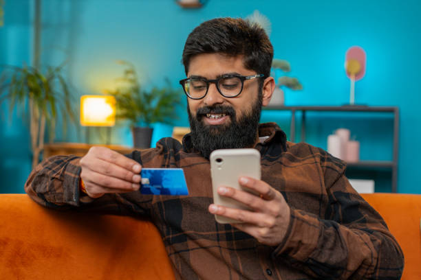 istock Happy Indian man doing smartphone payments online purchase shopping in internet store credit card 2175360079