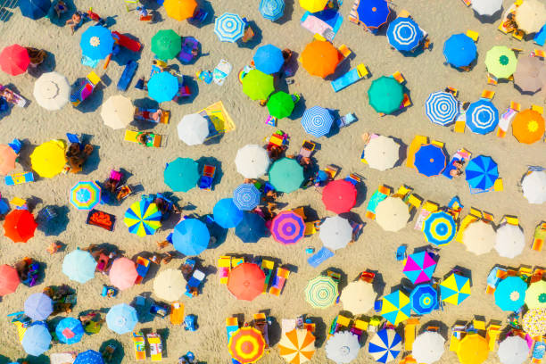 istock Umbrellas as a background from top view. Beach and sand background from drone. Summer seascape from air. View on the coast from drone. 2175370774