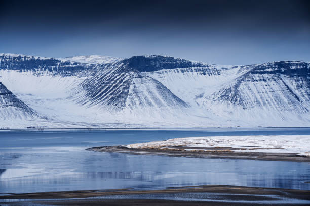 istock Snow-covered mountains reflecting in icy lake 2175373357