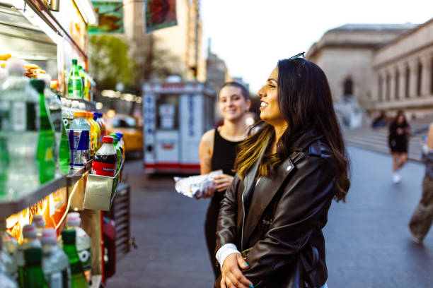 istock Street Food Delight: Two Women Enjoying Daytime Snacks 2175373507