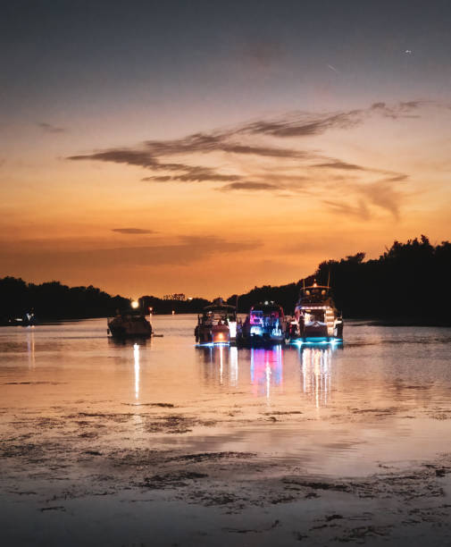 Recreational boats anchored side by side for a boat community party and socializing.