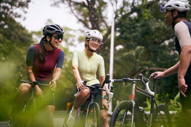 istock young asian cyclists chatting outdoors 2175379345