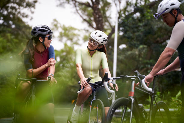 istock young asian cyclists chatting outdoors 2175379347