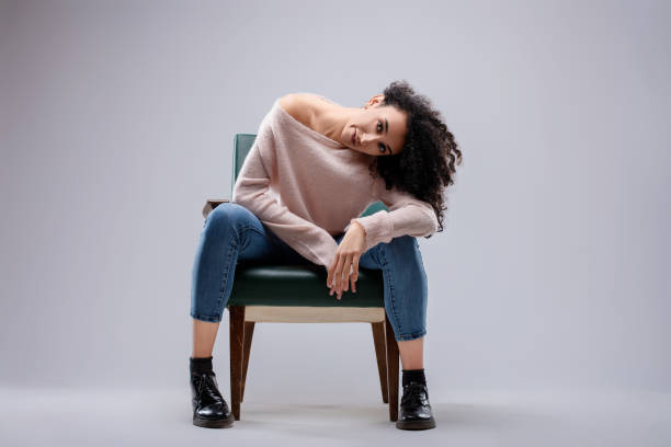 istock Fashion model posing while sitting on a vintage armchair 2175382567