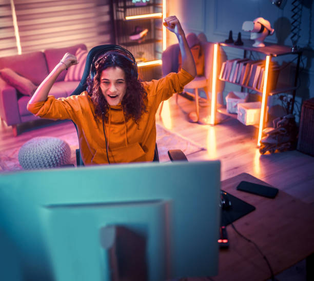 istock Young girl playing video games at home 2175383655