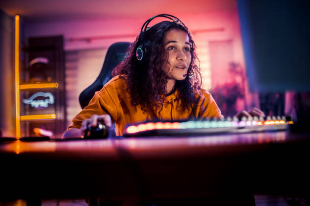 istock Young girl playing video games at home 2175383673