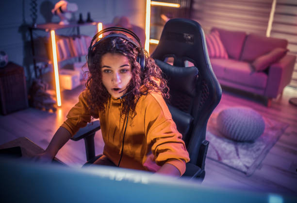 Young girl playing video games at home