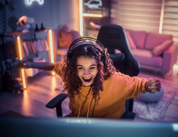 istock Young girl playing video games at home 2175383735