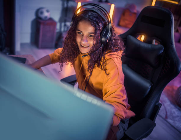 istock Young girl playing video games at home 2175383767