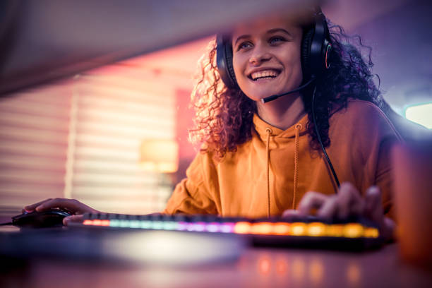 istock Young girl playing video games at home 2175383934