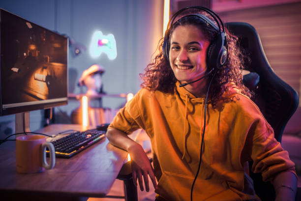 istock Young girl playing video games at home 2175384008