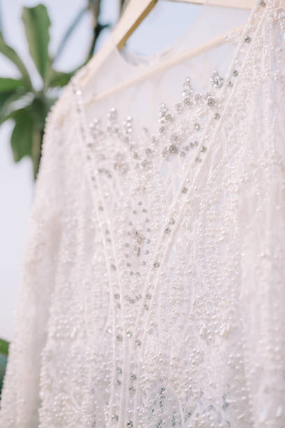 istock A wedding gown elegantly hung on a tree branch 2175385276