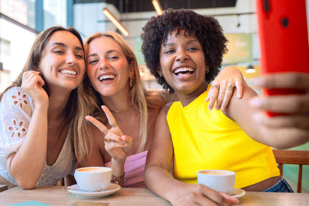 istock Three multiracial Friends Taking a Selfie in a Cafe 2175388879