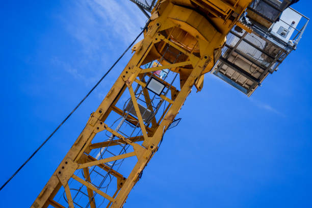 istock A large yellow crane stands out against a bright blue sky 2175389803