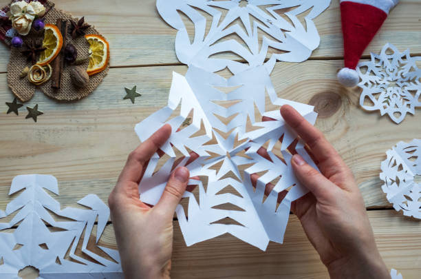 istock A snowflake made from paper with your own hands gracefully decorates a winter interior, adding warmth and a cozy atmosphere 2175391053