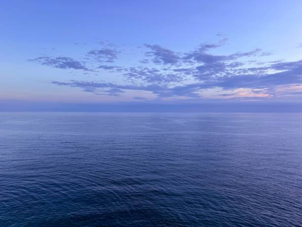 istock Ocean water calm ripples surface and dark clouds in the sky at evening 2175391247