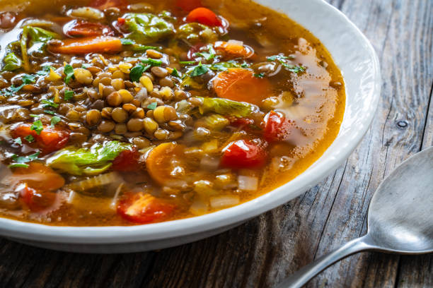 istock Fresh vegetable soup with lentil served in white bowl on wooden table 2175391499