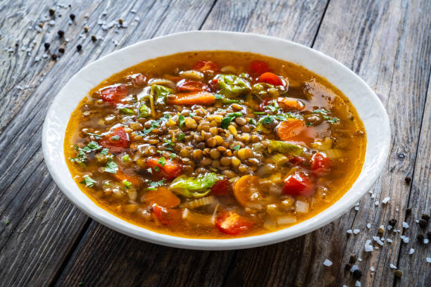 istock Fresh vegetable soup with lentil served in white bowl on wooden table 2175391506