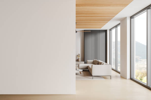 istock Stylish home living room interior with sofa, sideboard and window. Mockup wall 2175392684