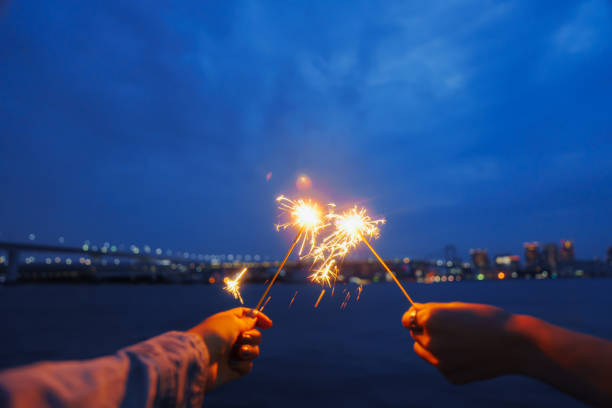Fireworks while looking out at the ocean at a park in Toyosu