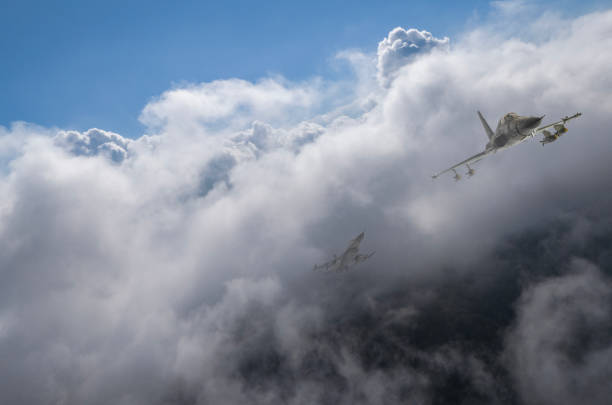 istock F-5 and F-16 jet aircrafts flying over clouds. 2175396125