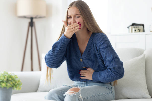 istock Young woman closing her mouth and feeling nauseous 2175396754