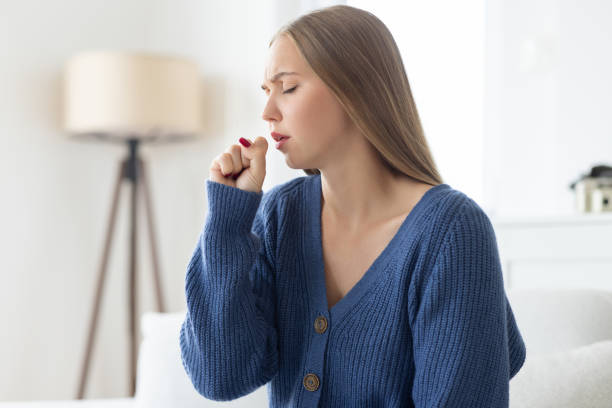 istock Woman coughing into her hand 2175396788