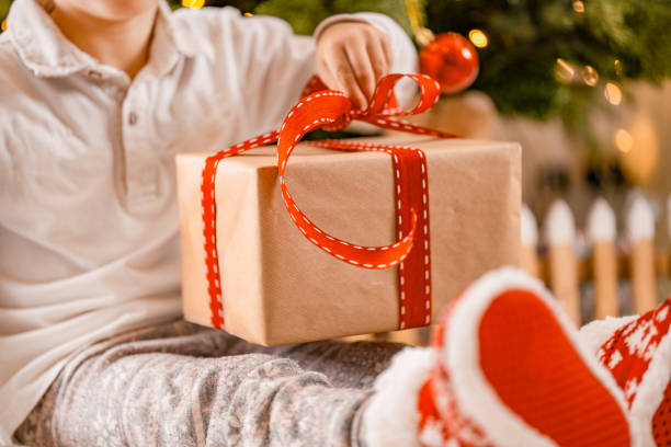 istock Child Opening Christmas Gift 2175398674