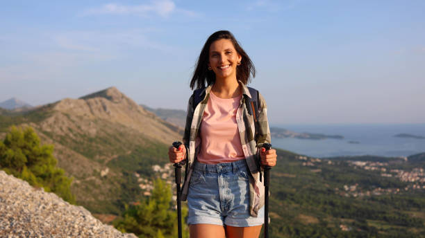 istock Cheerful young lady savoring a mountain hike 2175401928