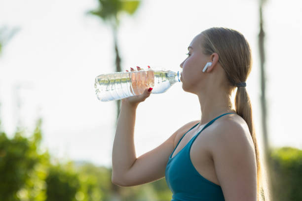 istock Attractive sporty woman drinking water from a bottle 2175402223