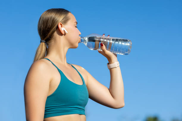 istock Young Woman Drinking Water After Workout 2175402411